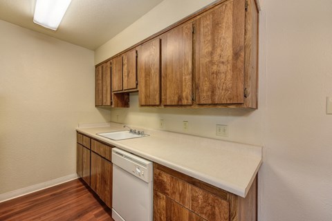 Kitchen with Hardwood Inspired Floors, Wood Cabinets and Dishwasher